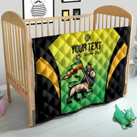 Black quilt in crib with yellow-green Jamaican jersey graphic and custom text, quilted pattern