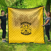 Yellow quilt blanket featuring Buffalo soldier patch logo, held outdoors