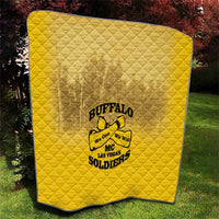 Yellow diamond-stitched quilt blanket with Buffalo soldier logo, outdoors on grass