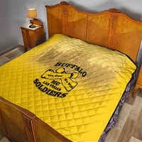 Yellow quilt blanket with Buffalo soldier logo over a bed mattress