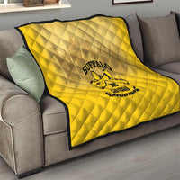 Yellow quilt blanket with Buffalo soldier logo draped over a gray couch