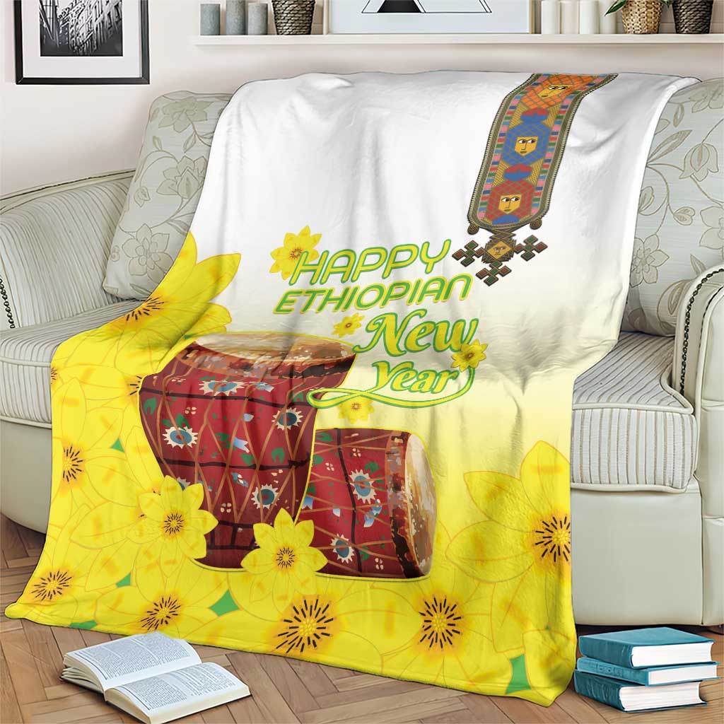 Yellow and white Ethiopian blanket with flower and drum print, draped on couch