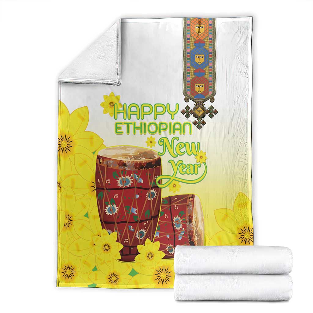 Yellow and white Ethiopian blanket with floral drum design, folded for display
