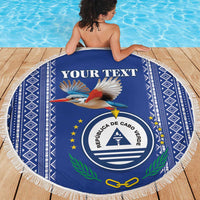 Personalized round beach blanket with white fringe, blue; coat of arms and bird artwork.