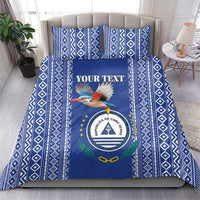Blue patterned bedding set with crest and bird, "YOUR TEXT" panel on duvet