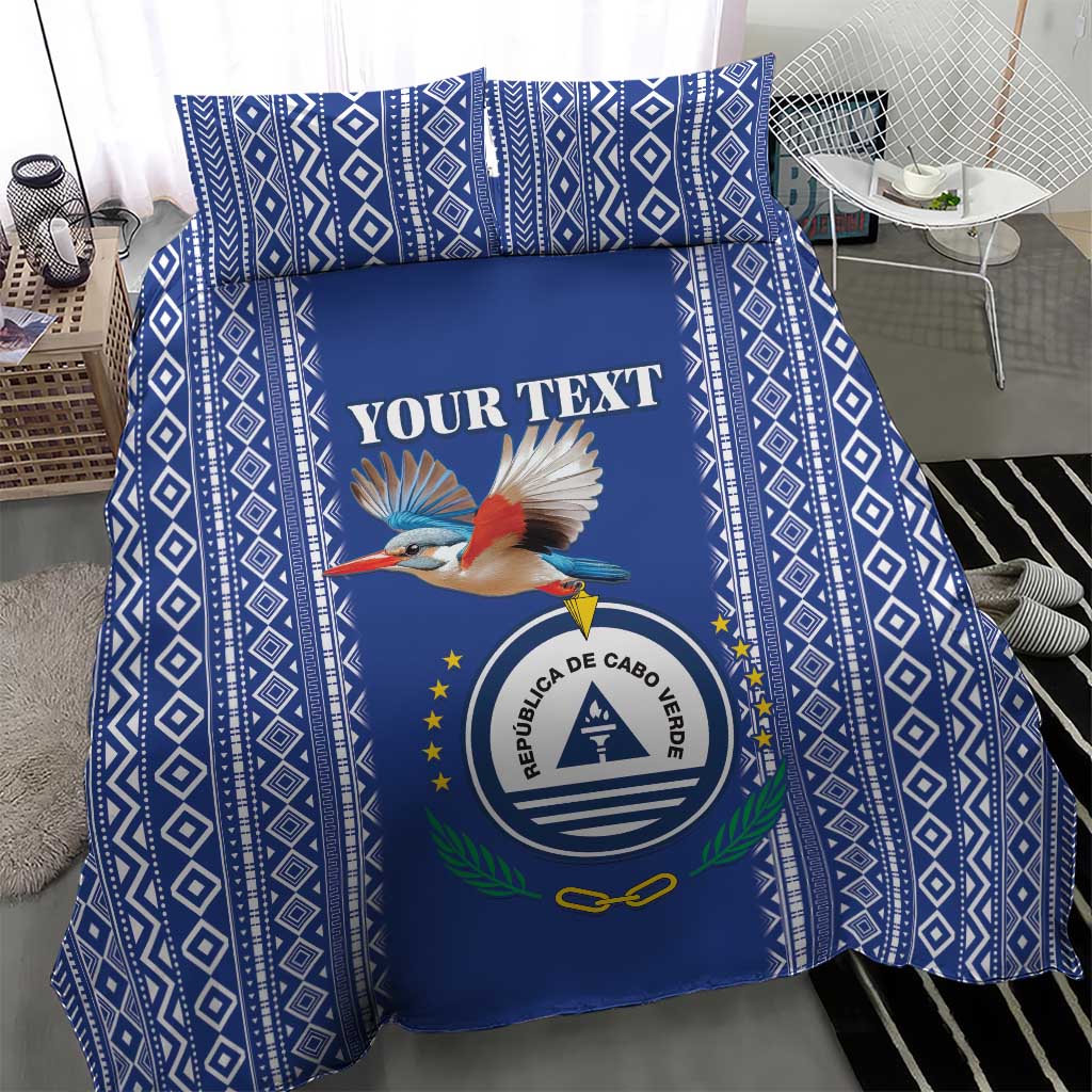 Blue patterned duvet with crest, bird graphic, and "YOUR TEXT" lettering