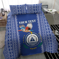 Blue patterned duvet with crest, bird graphic, and "YOUR TEXT" lettering