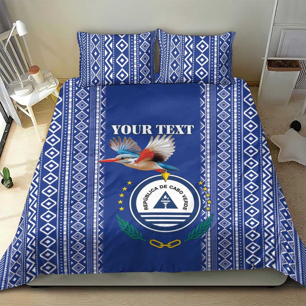 Blue patterned bedding set with geometric border, crest, bird, and "YOUR TEXT" panel
