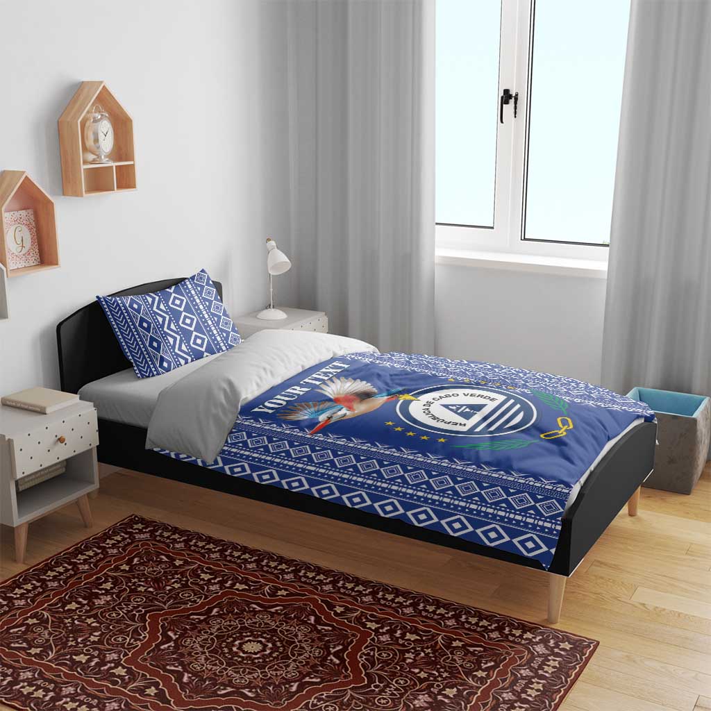Blue patterned bedding set with crest-and-bird duvet and matching pillowcases on bed