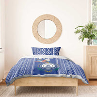 Blue patterned duvet with crest-and-bird emblem and geometric border
