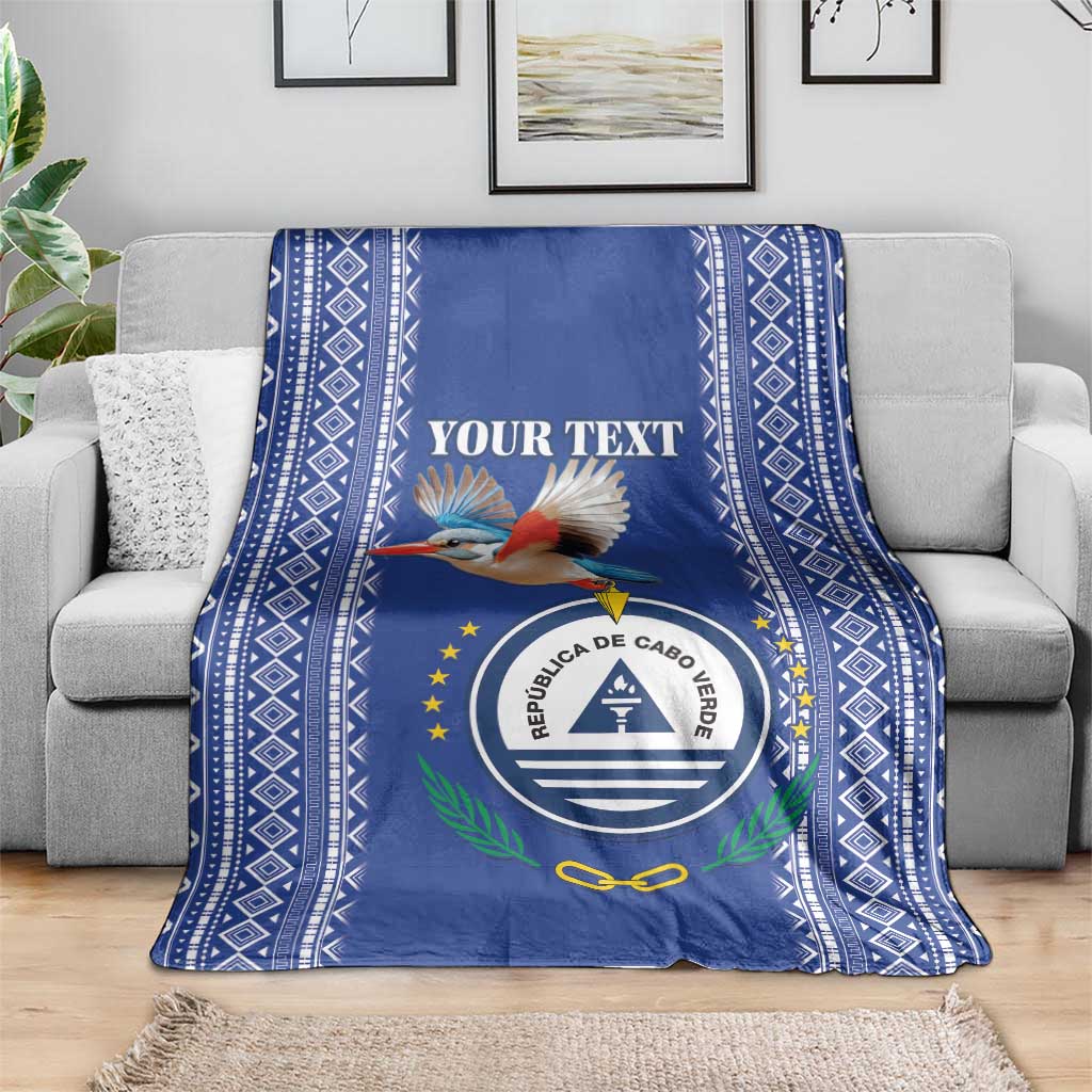 Personalized blue blanket with bird graphic, round crest emblem, and diamond side panels