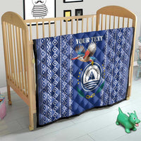 Blue quilt for crib with diamond pattern border and Cape Verde crest center