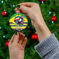 Handheld round ceramic ornament in green and yellow with toucan and Brasil text.