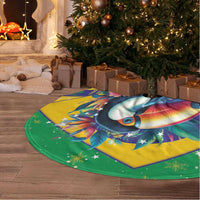 Round Brazil-themed Christmas tree skirt on floor, green/yellow toucan 'BRASIL' flag design, fringe.