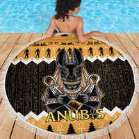 Round beach blanket with central Anubis portrait, black and gold hieroglyph pattern, white fringe