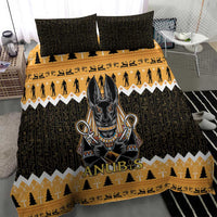 Black and gold Anubis jackal bedding set with orange band and chevron trim on duvet