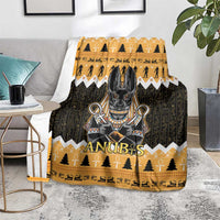 Orange and dark Anubis-themed blanket on a living room floor, showing central Anubis graphic