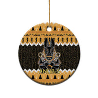 Orange round ceramic Anubis ornament with black hieroglyph pattern and gold hanging loop