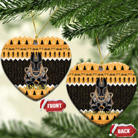 Orange heart-shaped ceramic Anubis ornament with black hieroglyph pattern and gold hanging loop