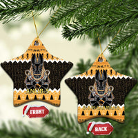Orange star-shaped ceramic Anubis ornament with black hieroglyph pattern and gold hanging loop