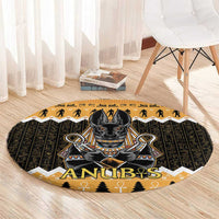 Round Anubis area rug with Egyptian symbols, dark base and orange border on wood floor