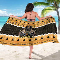 Orange and black Anubis graphic sarong draped at the waist with zigzag edge