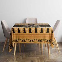 Orange and black patterned tablecloth on dining table with chair backs