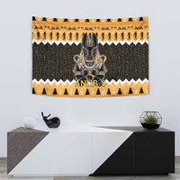 Centered Anubis face on orange and dark green tapestry with hieroglyph-style rows