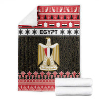 Folded Egypt blanket set with red and black design, gold shield, and stacked white towels