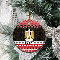 Egypt coat of arms ceramic ornament, round red and black with gold shield on tree branches