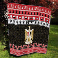 Egypt quilt blanket with red top border, black patterned field, and gold coat-of-arms motif