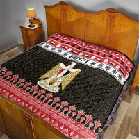 Egypt-themed quilt blanket on bed with red border, black pattern, and gold coat-of-arms artwork
