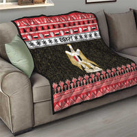 Egypt quilt blanket on sofa in red, white, and black with gold coat-of-arms center graphic