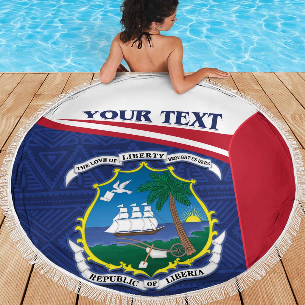 Round Liberia beach blanket with blue graphics, red panel, and white fringe border.