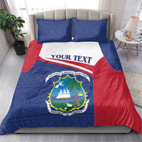 Personalized Liberia duvet and pillowcases in blue with red trim and “YOUR TEXT” banner.