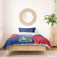Personalized Liberia duvet cover with blue patterned fabric, red panel, and coat of arms.