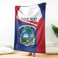 Liberia blanket coat draped on floor with blue front, red side panels, and crest