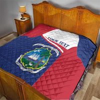 Liberia quilt coat of arms blanket on bed, red white and blue with emblem and text
