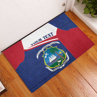 Personalized rubber doormat with blue geometric design, red corners, 'YOUR TEXT' banner