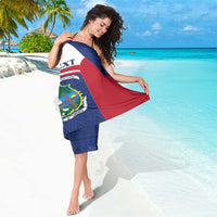 Personalized sarong coat draped over shoulder, blue patterned border with Liberia coat-of-arms