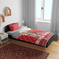 Red Christmas duvet and pillows on bed, showing alpaca and “Peru” design