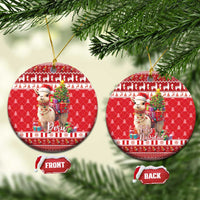 Red round ceramic Christmas ornament set with alpaca holding gifts; shows Peru and Feliz Navidad.