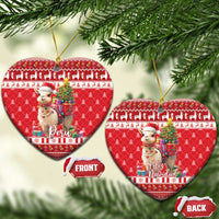 Red heart-shaped ceramic ornament set with alpaca holding gifts; shows Peru and Feliz Navidad.
