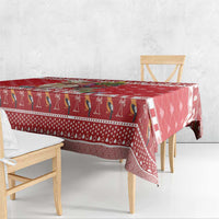 Red tablecloth with llama border stripe and hanging end trim, draped over table.