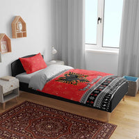 Red duvet cover with eagle design and patterned border, shown with two pillowcases