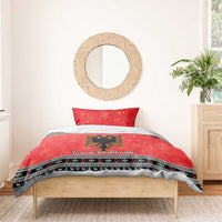 Red Christmas duvet cover with eagle emblem and black patterned stripes, paired with one pillow