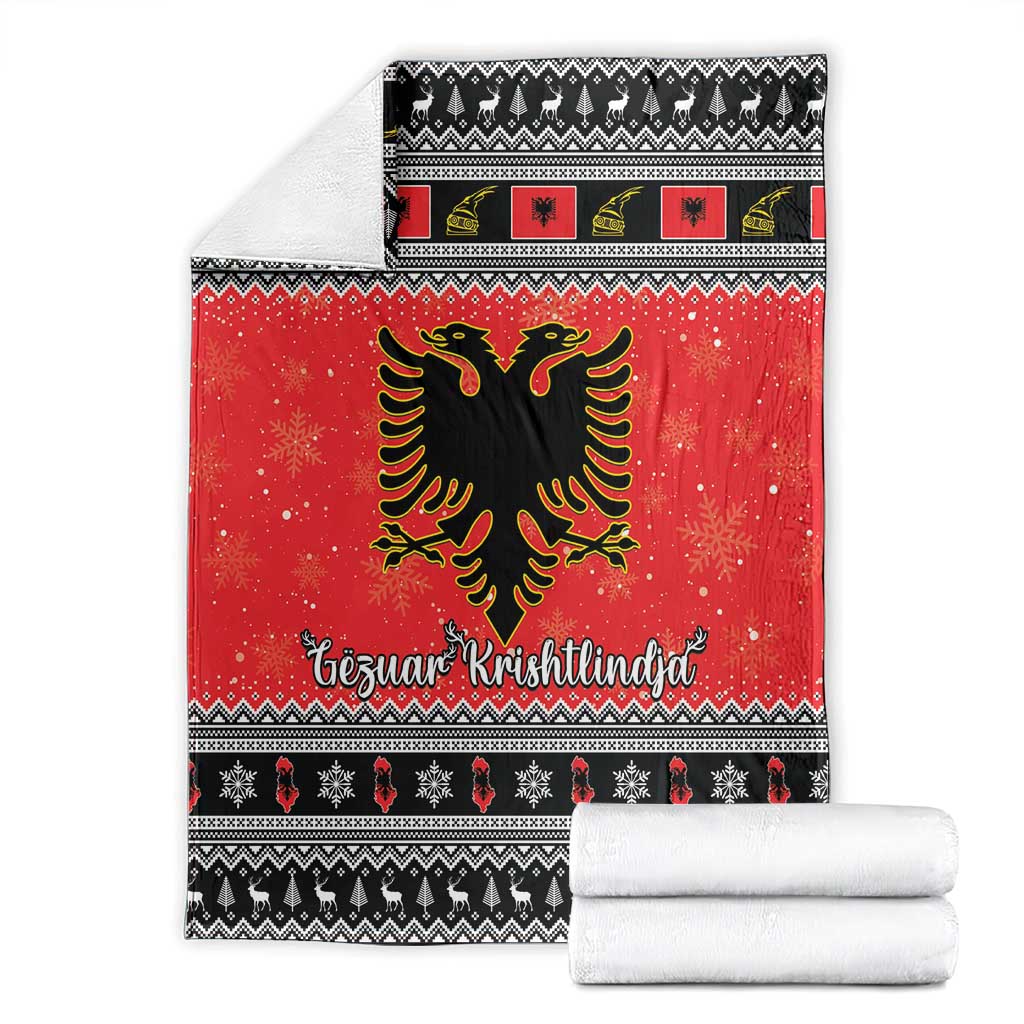 Red Christmas blanket with Albanian eagle design, black patterned band, and folded white towels