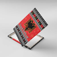 Angled view of red canvas wall art with Albanian double-headed eagle and Gezuar Krishtlindja text