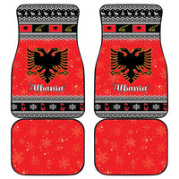 Red car floor mats set with Albania lettering, black eagle graphics, and winter snowflake border