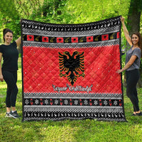 Red quilt blanket with black-and-white geometric border and Albanian eagle center graphic